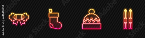 Set line Winter hat, Bow tie, Christmas stocking and Ski and sticks. Glowing neon icon. Vector