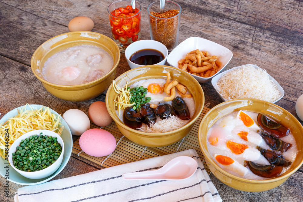 Thai food Breakfast set - soft boiled egg and minced pork ball with rice porridge with century egg and sliced liver topping by crispy noodle Thai food Breakfast set - soft boiled egg and minced pork ball with rice porridge with century egg and sliced liver topping by crispy noodle
