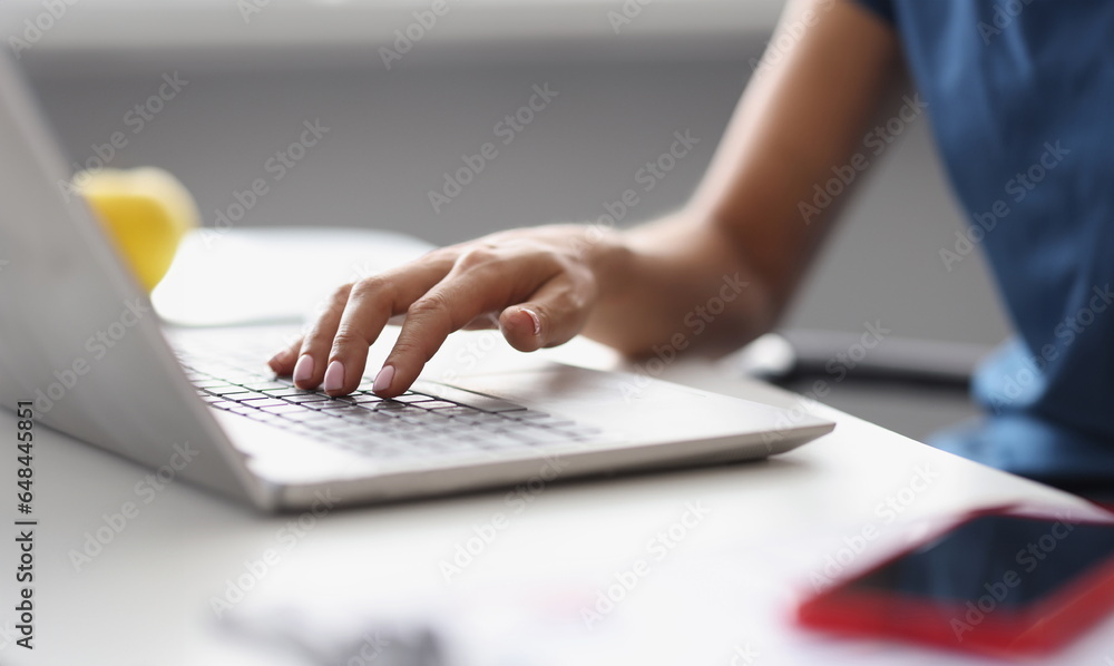 Female hands typing on the laptop keyboard at workplace. Copywriting profession training concept Female hands typing on the laptop keyboard at workplace. Copywriting profession training concept