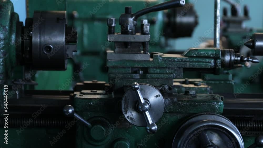 an old lathe in the workshop of the factory an old lathe in the workshop of the factory