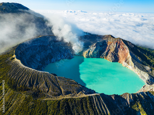 Aerial view of rock cliff at Kawah Ijen volcano with turquoise sulfur water lake at sunrise.Amazing nature landscape view at East Java, Indonesia. Natural landscape background photo