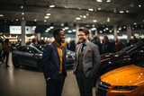 Portrait of a car dealer and a buyer standing among luxury cars