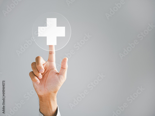 Fototapeta Naklejka Na Ścianę i Meble -  Businessman hand taps a virtual plus sign, representing positivity. Conveys ideas of increased benefits, progressive thinking, and a positive mindset. Business and success concept. positive thing