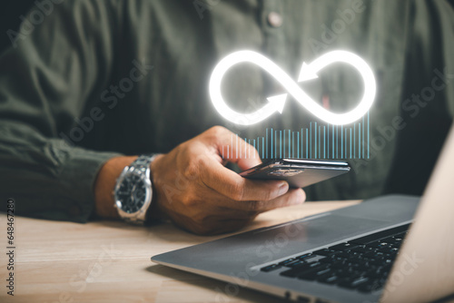 Canvastavla Businessman presents smartphone with infinity symbol, signifying limitless connection in data technology, future unlimited