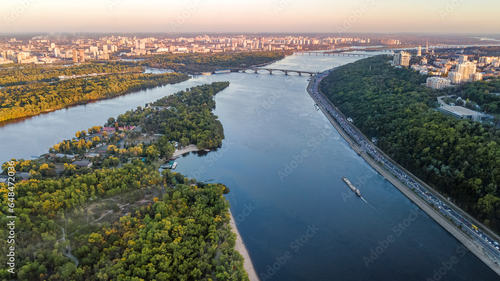 Kyiv city skyline and Dnipro river aerial drone view from above, Kiev bridges and Dnieper river islands in spring, Ukraine