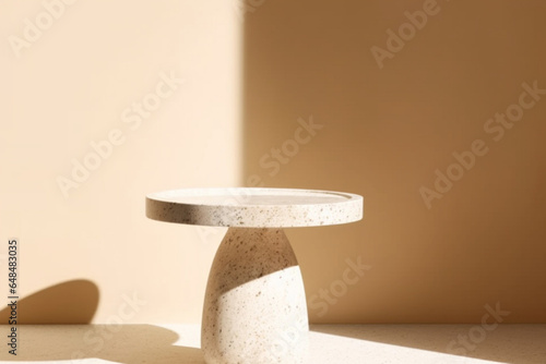 Modern and minimal round white granite pedestal table podium with sunlight and shadow on beige brown wall