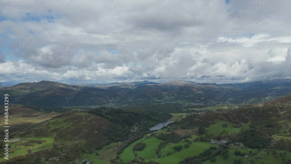 A drone view of the colourful British countryside with mountains and fluffy clouds. A drone view of the colourful British countryside with mountains and fluffy clouds.