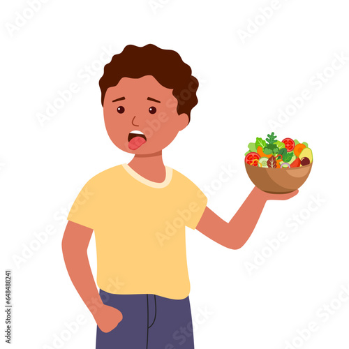 Cute little African boy picky eater refusing to eat vegetables.
