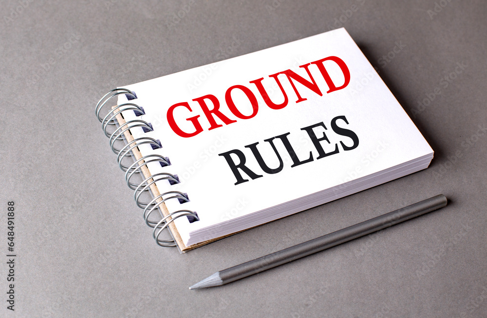GROUND RULES word on notebook on grey background