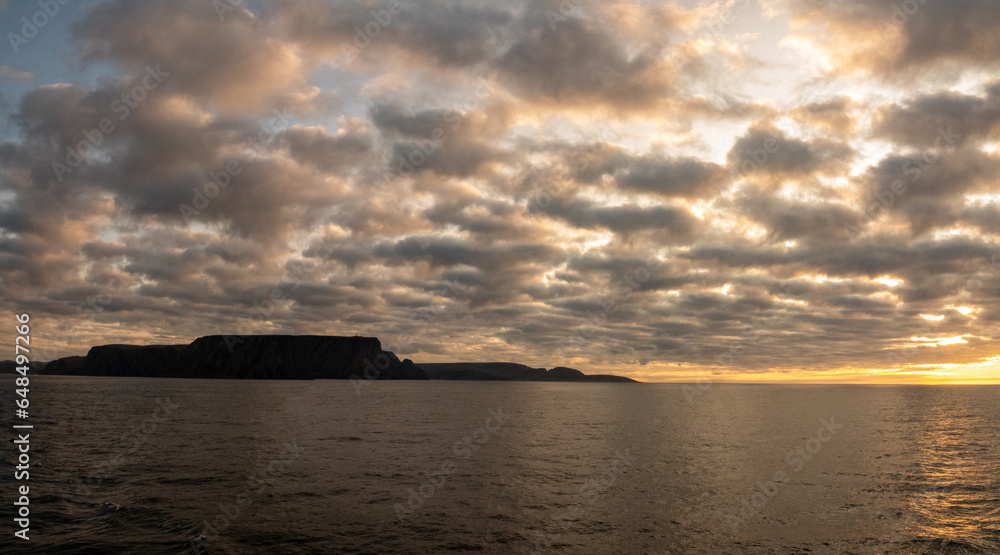 Midnight sun over the Nordkapp (North Cape), view froma ship, Troms of Finnmark, Norway. commonly referred to as the northernmost point of Europe Midnight sun over the Nordkapp (North Cape), view froma ship, Troms of Finnmark, Norway. commonly referred to as the northernmost point of Europe
