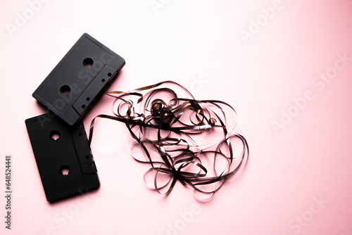 Cassette ribbons on a light pink background