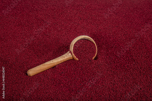 Dry spice sumac in a wooden spoon. Ground sumac spice. Dried ground red Sumac powder spices in wooden spoon with sumac berries on rustic table. Healthy food concept.