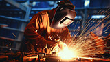 Industrial worker welding metal with many sharp sparks