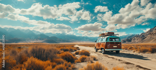 A vintage van traveling, nomadic escape alone in nature at sunset, on a desert path for a road trip towards adventure, exploration and freedom photo