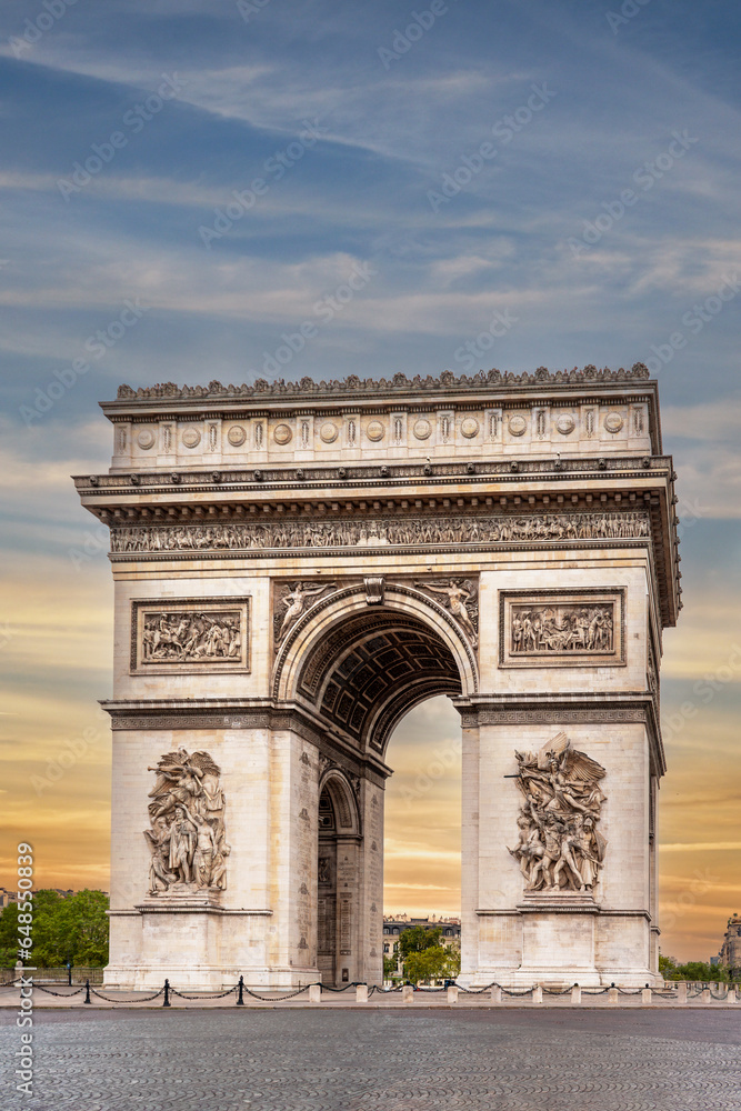 Paris, France: Arc de Triomphe in De Gaulle Square at the end of the Champs Elysées. Sky with sunset colors