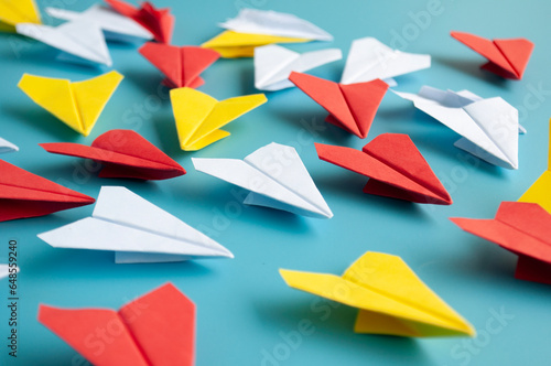 Fototapeta Naklejka Na Ścianę i Meble -  Yellow paper plane origami leading other white paper planes on blue background. Leadership concept. Origami concept.