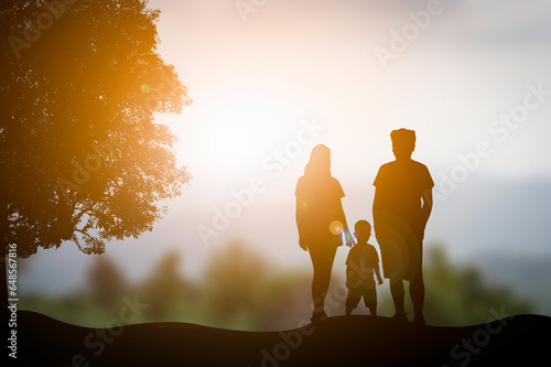 A silhouette family with blur orange sunset background