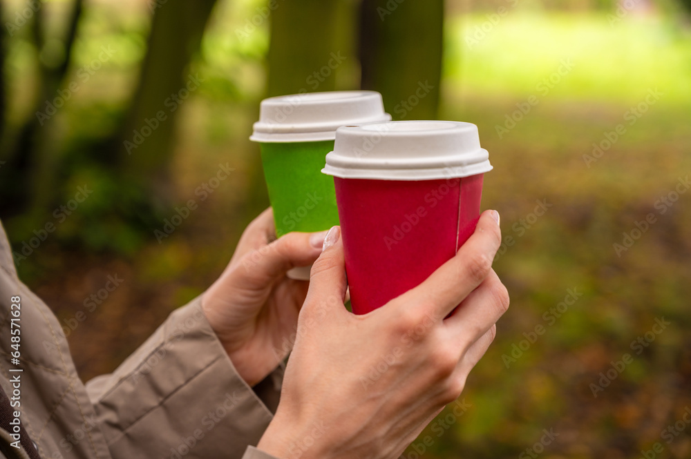 paper coffee cups in women's hands
paper coffee cups in women's hands