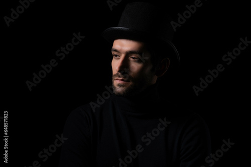 Pensive thinking handsome young beared man portrait Attractive bearded confident guy wear hat looking at blank space Smart man thinking in the dark room Cool man is good looking guy and smart guy