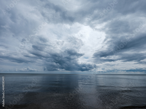 white rain clouds over countryside in summer