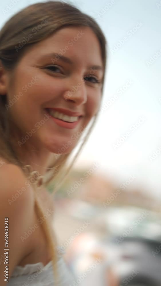 Vertical video of a woman with flowing hair in a captivating white dress Vertical video of a woman with flowing hair in a captivating white dress