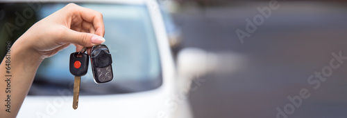 woman holding car key