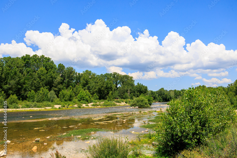 The river Gardon in France near Pont-du Gard on a summer day with blue sky and cumulus clouds