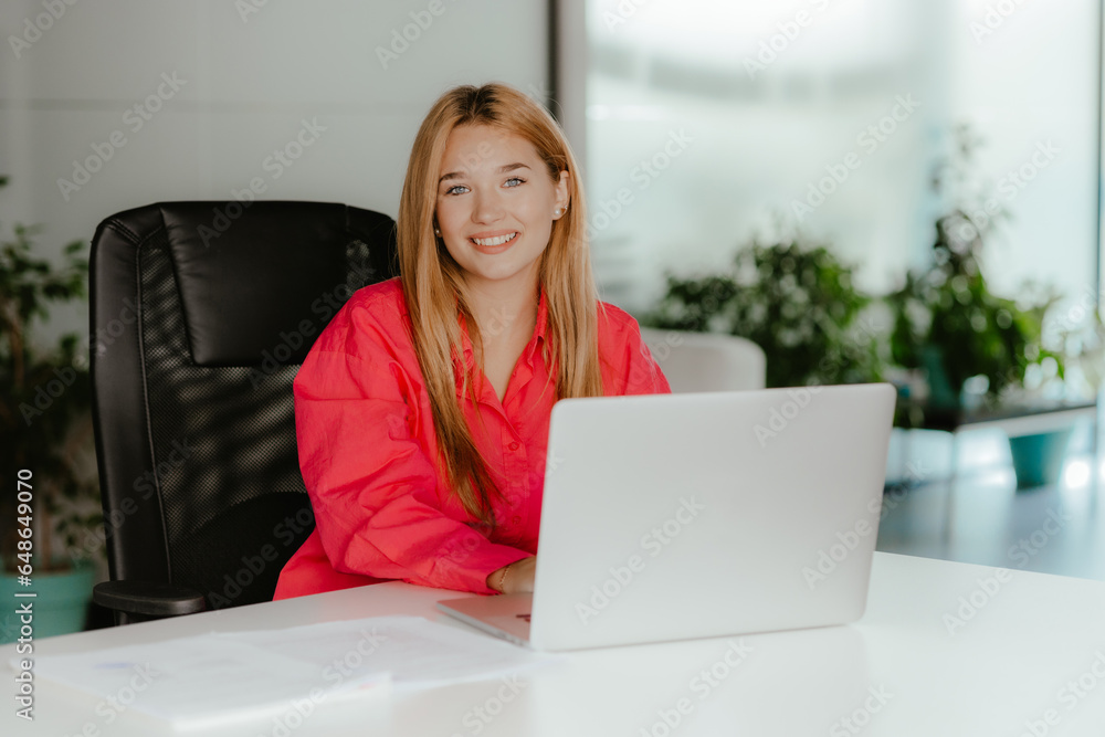 Young smiling lady with a computer. Happy employee at the desk. Young smiling lady with a computer. Happy employee at the desk.