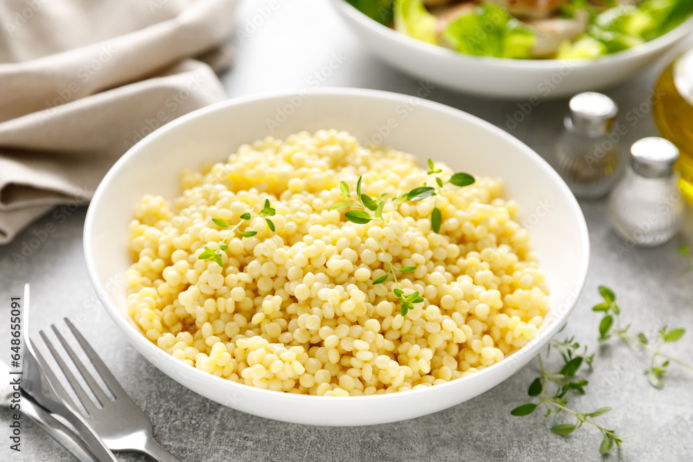 Couscous with chicken patties, cutlets with fresh romaine lettuce salad, top down view Couscous with chicken patties, cutlets with fresh romaine lettuce salad, top down view