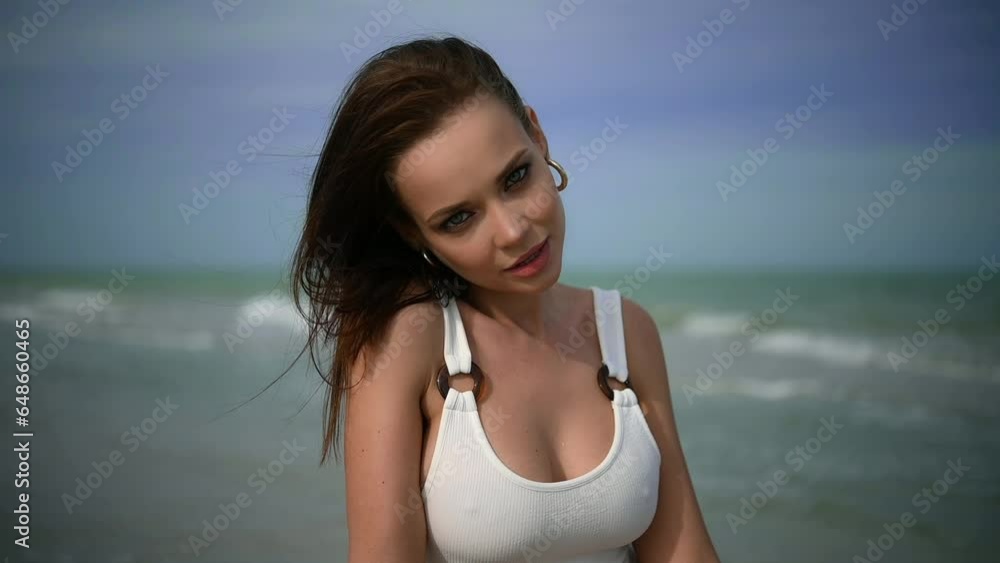 Girl on the beach. Sexy brunette in swimsuit. Girl on the seashore. Young woman in bikini swimsuit. Woman in swimsuit. Girl on the beach. Sexy brunette in swimsuit. Girl on the seashore. Young woman in bikini swimsuit. Woman in swimsuit.