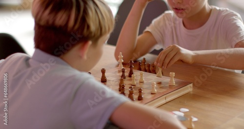 Schilderij op canvas Children Engaging in Chess at School Competitions