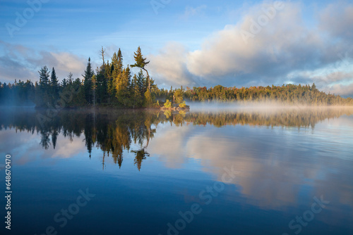 Small island with trees on a foggy northern Minnesota lake at sunrise in September © Daniel Thornberg