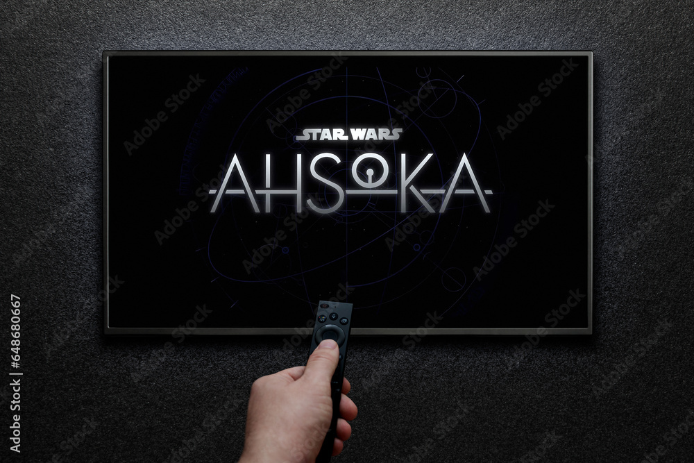 Obraz premium Ahsoka trailer or movie on TV screen. Man turns on TV with remote control. Astana, Kazakhstan - September 8, 2023.