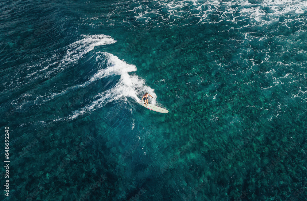 Fototapeta premium Surfer girl on a wave in Hawaii longboard surfboard
