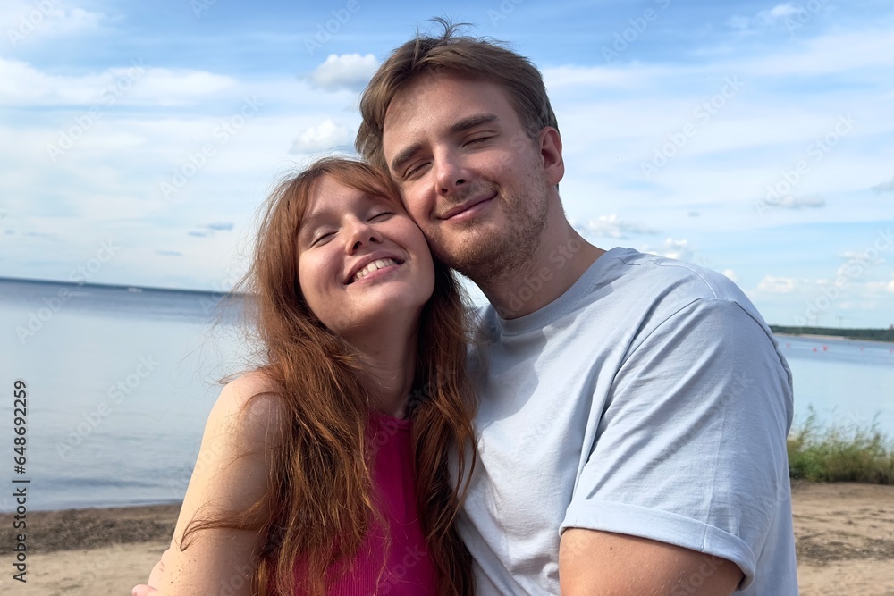 Happy couple in love hug each other, walk on natural background at summer day Happy couple in love hug each other, walk on natural background at summer day