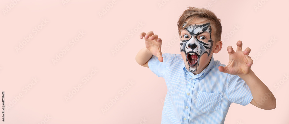 Funny little boy with face painting on pink background with space for text Funny little boy with face painting on pink background with space for text