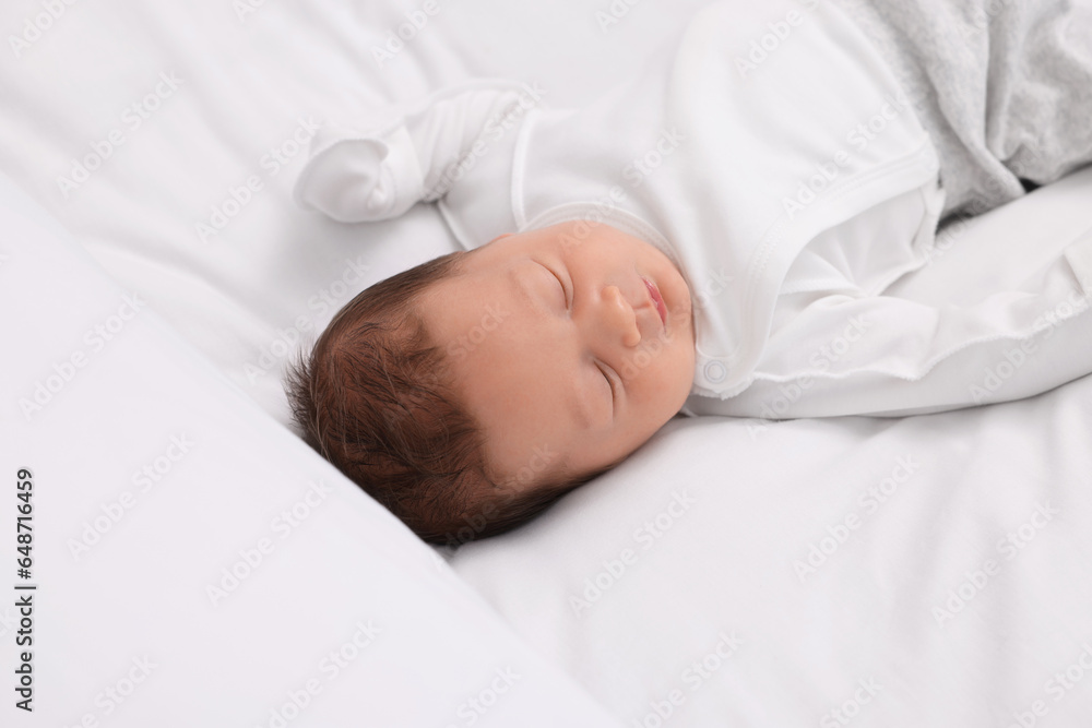 Cute newborn baby sleeping on white bed Cute newborn baby sleeping on white bed