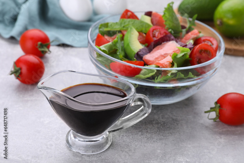 Soy sauce and vegetable salad on grey table  selective focus