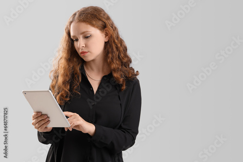 Young businesswoman with ta...