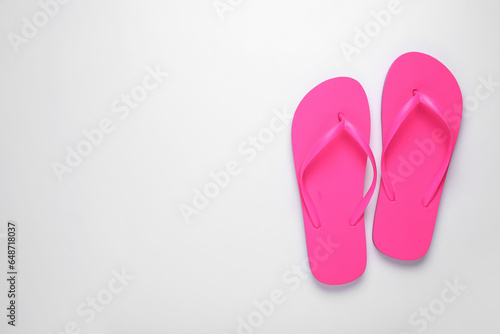Stylish pink flip flops on white background, top view. Space for text