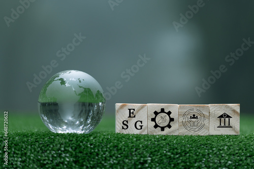 Words ESG on a woodblock It is an idea for sustainable organizational development. ​account the environment, society and corporate governance. ESG concept of environmental, social and governance.