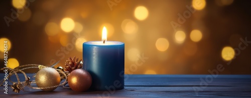 Christmas burning blue candle and christmas decorations on wooden background  horizontal greeting and invatation banner with copy space for advertisement and other usage