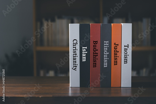 Book spines listing major world religions - Christianity, Islam, Hinduism, Buddhism, Taoism and Judaism. religion concept. photo