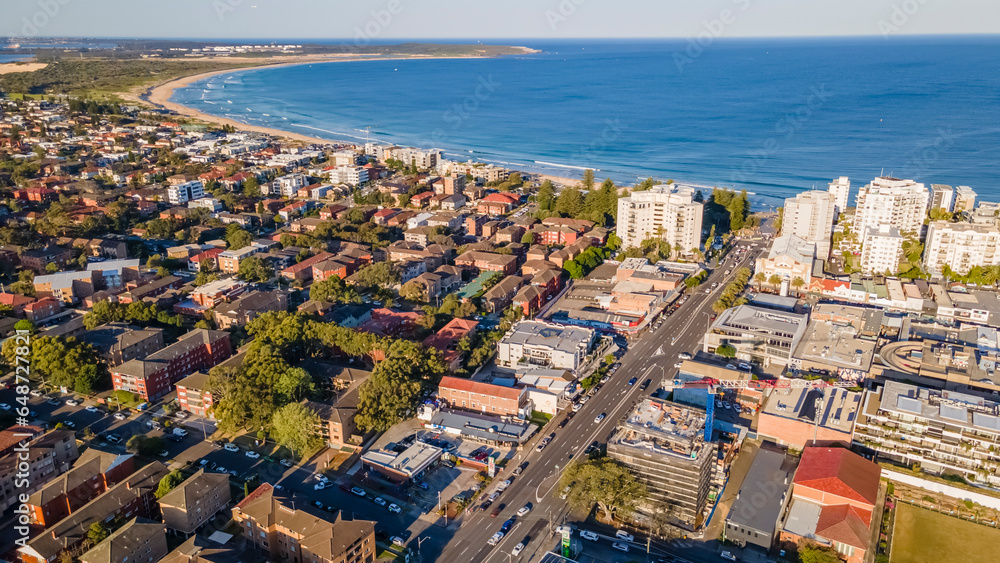 Fototapeta premium Aerial drone view above Cronulla in the Sutherland Shire, South Sydney, NSW Australia looking in the east direction on a sunny afternoon in September 2023 