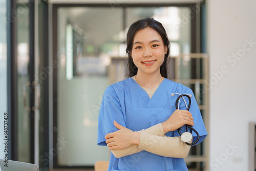 Portrait of a professional female doctor with a stethoscope standing with crossed arms. Free Download Portrait of a professional female doctor with a stethoscope standing with crossed arms. - GFXLoad