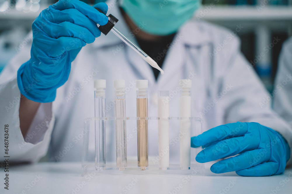 Food scientist testing milk samples of dairy products in the laboratory. Researchers are looking at the stratification of milk. Food scientist testing milk samples of dairy products in the laboratory. Researchers are looking at the stratification of milk.