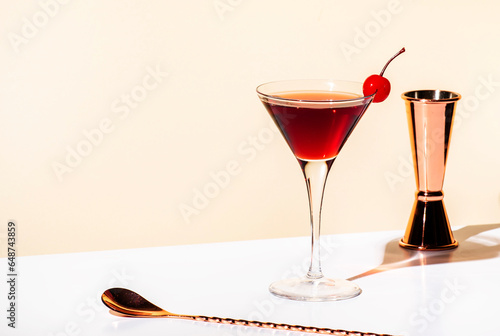 Black Manhattan alcoholic cocktail with whiskey and red vermouth garnished with maraschino cherry in martini glass. Beige background, hard light photo