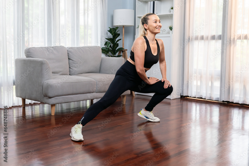 Active and fit senior woman warmup and stretching before home exercising routine at living room. Healthy fitness lifestyle concept after retirement for pensioner. Clout