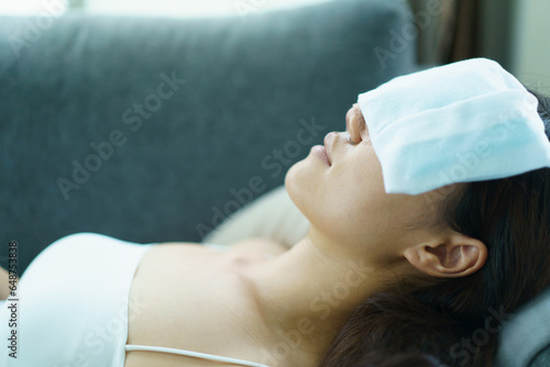 Photography Asian woman using an ice or cold pack compress at surgery wound.