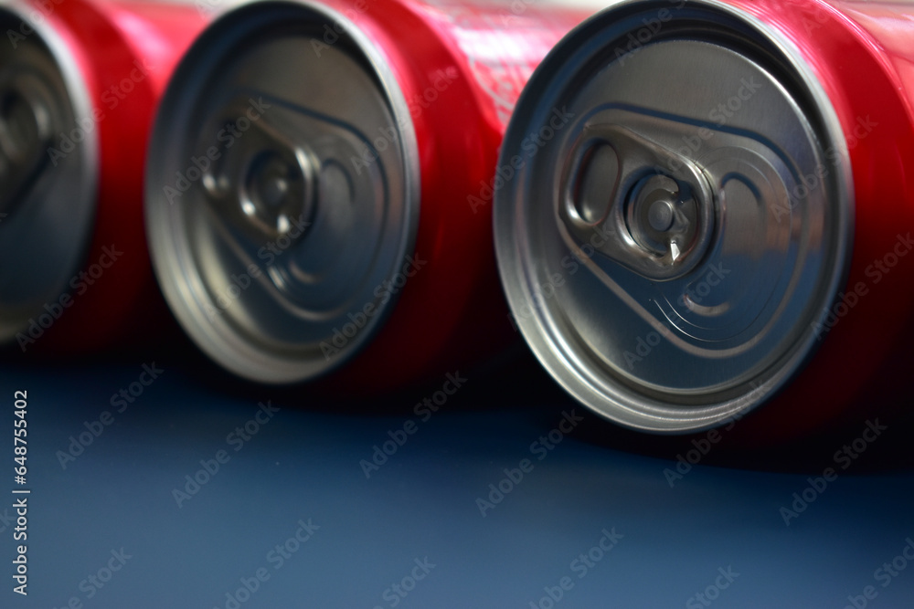 close up group of aluminium red cans soft drink put on blue texture background close up group of aluminium red cans soft drink put on blue texture background